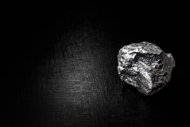istock big big silver nugget on black background. Raw silver stone, silver nugget native to Liberia, isolated on black background. Mineral extraction. 1216037128