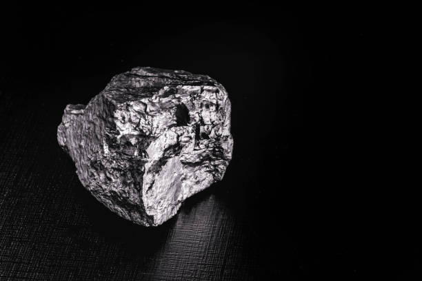 istock big big silver nugget on black background. Raw silver stone, silver nugget native to Liberia, isolated on black background. Mineral extraction. 1216037129