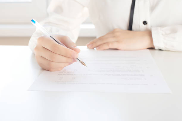 istock Making a mortgage. A man holds a pen for signing documents 1216039052