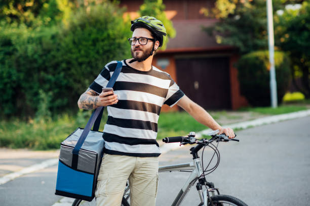 istock Delivery man working on a bike 1216040511
