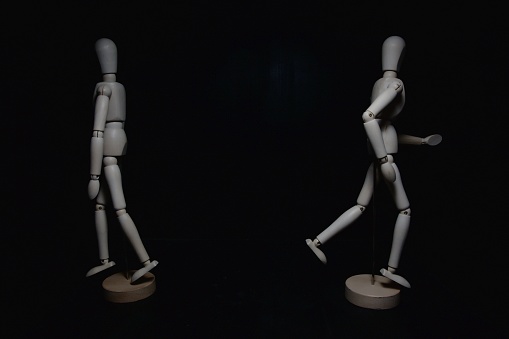 Two drawing mannequins moving in opposite directions