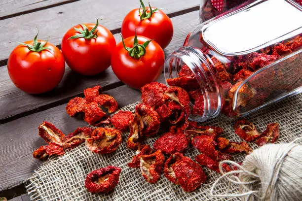 Healthy sun dried tomatoes on wooden background