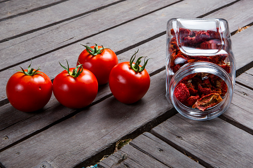 Healthy sun dried organic tomatoes on wooden background
