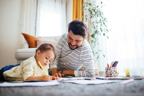 istock Young dad have fun drawing with little daughter 1216044593