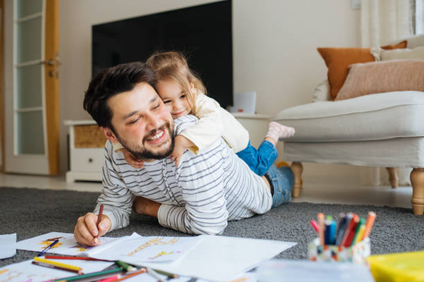 istock Young dad have fun drawing with little daughter 1216045476