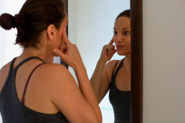 istock Woman stretching under eye wrinkles 1216045534
