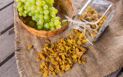 Healthy sun dried organic grapes on wooden background