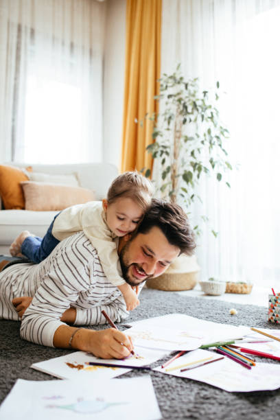 istock Young dad have fun drawing with little daughter 1216047012