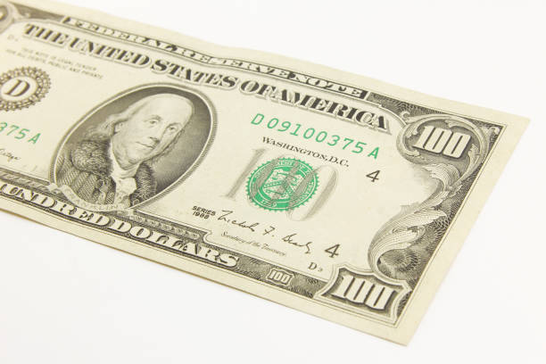 istock One hundred dollar cash banknotes on white background 1216047936