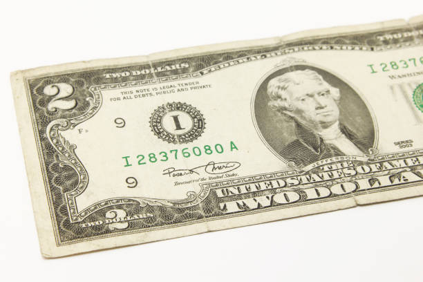 istock Two dollar bills in cash on white background. 1216047961