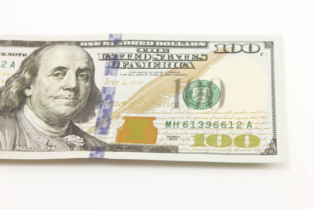 istock One hundred dollar cash banknotes on white background 1216047971