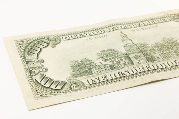 istock One hundred dollar cash banknotes on white background 1216048005