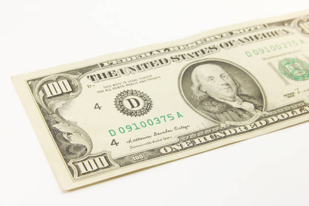 istock One hundred dollar cash banknotes on white background 1216048015