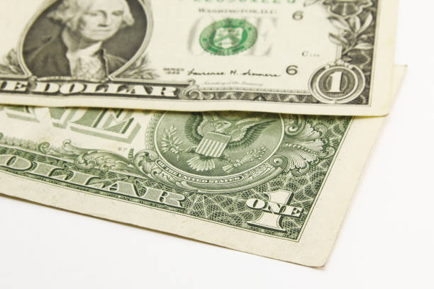 istock One dollar cash bills on white background 1216048037