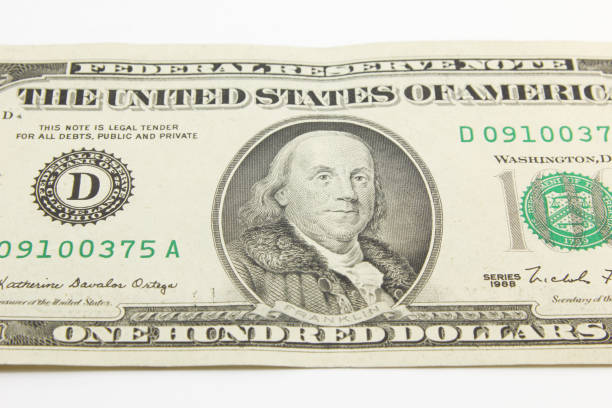 istock One hundred dollar cash banknotes on white background 1216048048