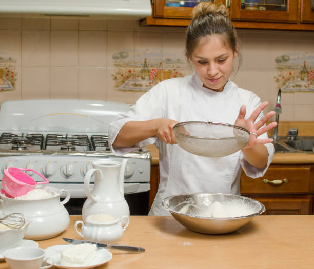 istock girl using ingredients to make a cake 1216048194
