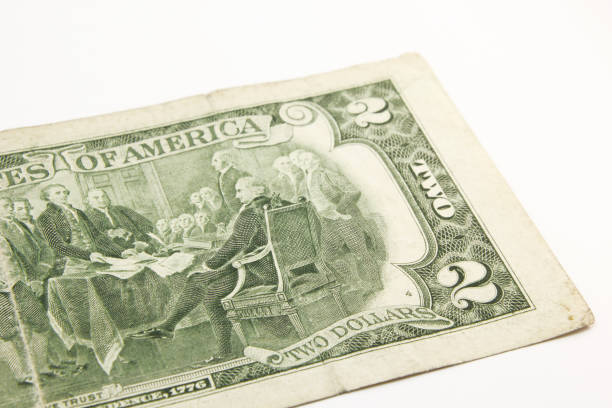 istock Two dollar bills in cash on white background. 1216048263