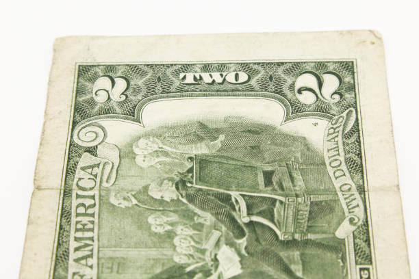istock Two dollar bills in cash on white background. 1216048438