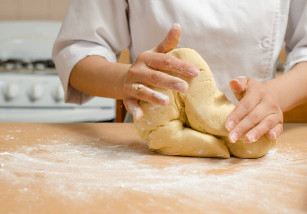 istock girl kneading cake dough 1216049930