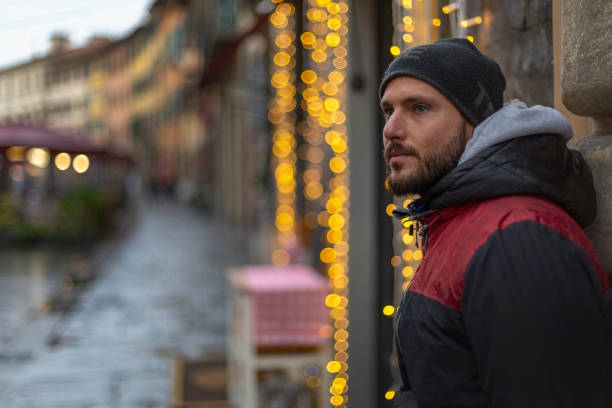 istock A young handsome bearded man standing and looking nowhere supported on a wall in Pisa, italy 1216052798