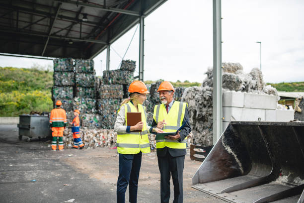 istock Quality Controllers in Discussion at Recycling Facility 1216056188