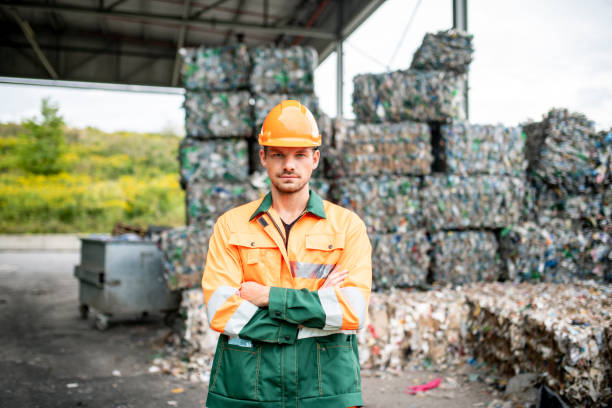 istock Serious Workman Standing Outdoors at Recycling Facility 1216056210