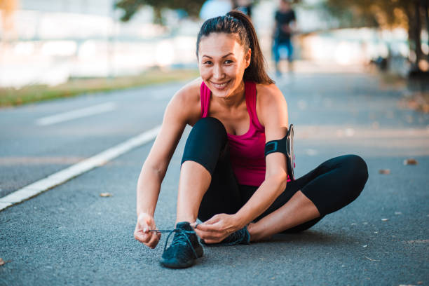 istock Charismatic woman sitting on the ground 1216056351