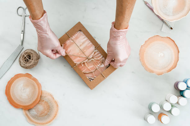 istock Creativity and craft. A young girl creates coasters from resin. Gift wrapping. Decorative packaging. Idea for business. Remote work, work at home. Art coasters. 1216056592