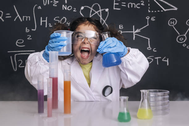 istock funny scientist girl in lab coat with flasks 1216057031