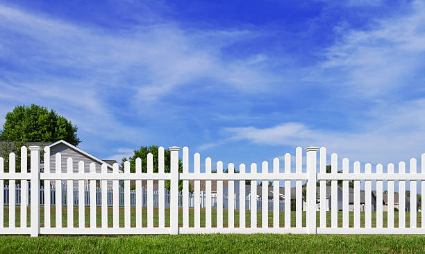 Picket fence with blue sky in the background.This image contains copy space for you message or design.Could be a useful element in a neighborhood composition. This is a detailed 3d rendering.