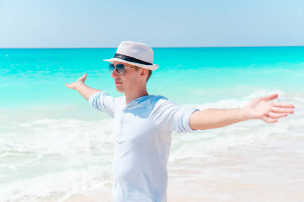 istock Young man on the white tropical beach 1216057825