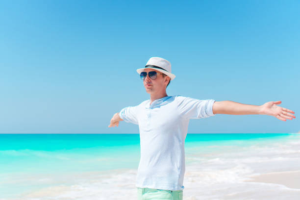 istock Young man on the white tropical beach 1216057830
