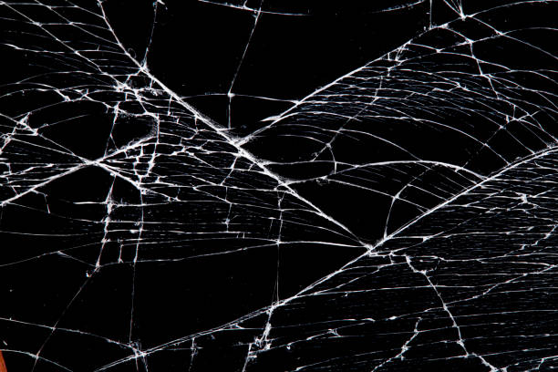 istock cracked glass isolated on a black background. 1216061099