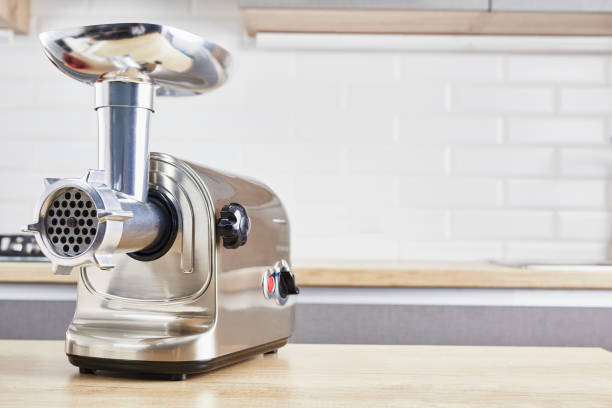 meat grinder on a wooden table in kitchen interior - meat grinder ground beef meat imagens e fotografias de stock