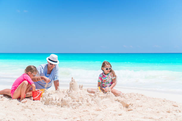 istock Happy beautiful family on a tropical beach vacation 1216070174