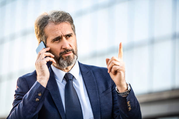 istock Bossy business leader having a phone conversation with assistants. 1216070853