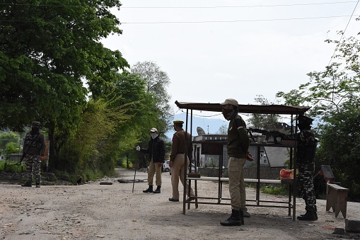 Security personals stand guard at checkpoints in Mendhar Sub Division of Poonch District (J&K) during 21 days lockdown to prevent COVID-19
