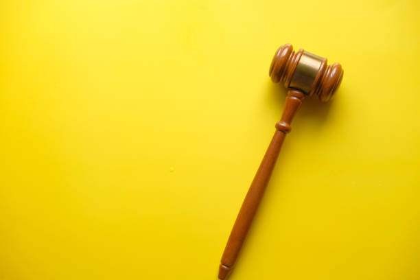 istock top view of single gavel on yellow background 1216073810