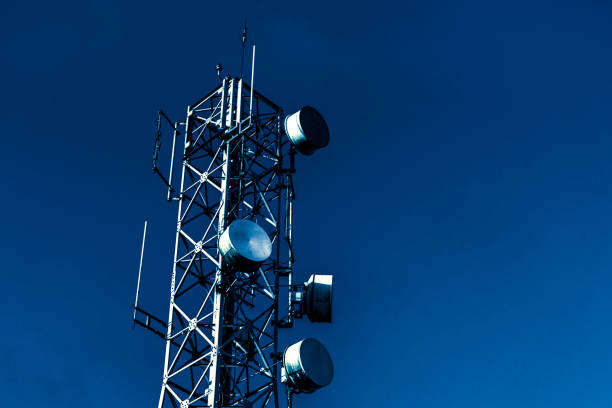 Telecommunication mast TV antennas wireless technology with blue Satellite Dish, Telecommunications Equipment, Antenna - Aerial, Computer Network, Internet launch tower stock pictures, royalty-free photos & images