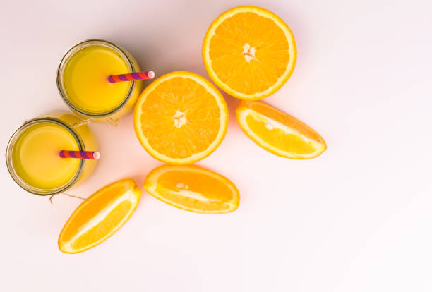 istock Orange juice in jars and fresh oranges on a white background. Copy space. 1216079992