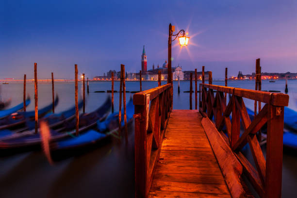 Early Morning view From St. Mark's Square in Venice Dawn breaks over the gondolas of Venice with the island of San Giorgio in the background venice italy grand canal honeymoon gondola stock pictures, royalty-free photos & images