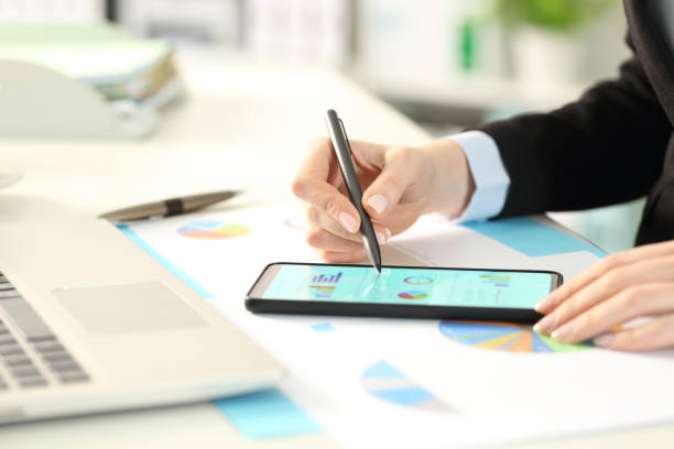 istock Business woman hands checking graphs on phone 1216081003