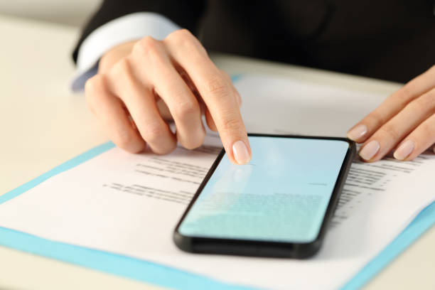 istock Executive woman hands signs contract on smart phone 1216081571
