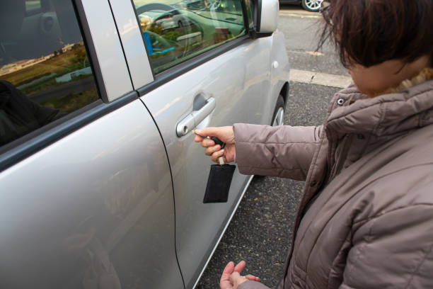 istock Elderly woman locking the car. 1216083605