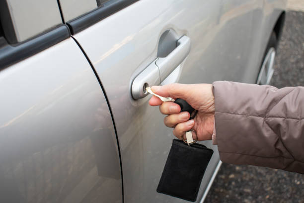 istock Elderly woman locking the car. 1216083619