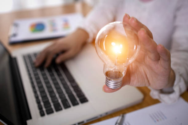 Business Woman holding light bulbs, ideas of new ideas with innovative technology and creativity. Business Woman holding light bulbs, ideas of new ideas with innovative technology and creativity. resourceful stock pictures, royalty-free photos & images