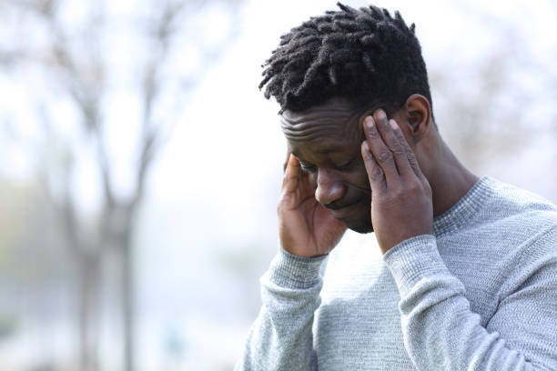 istock Black man suffering migraine outdoors 1216086998
