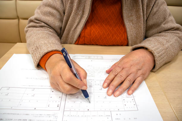 istock Elderly woman writing marriage registration 1216088188