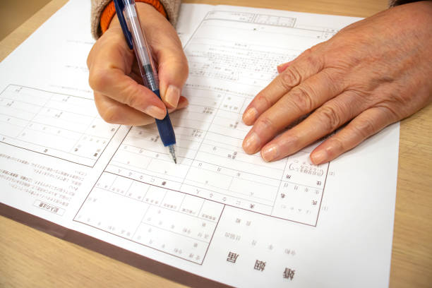 istock Elderly woman writing marriage registration 1216088202