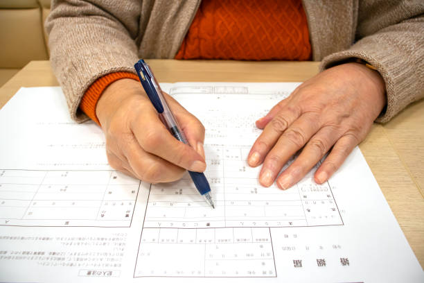 istock Elderly woman writing marriage registration 1216088232